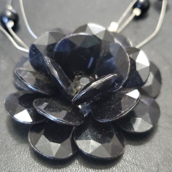 Silver tone black flower floating necklace - Picture 3 of 11